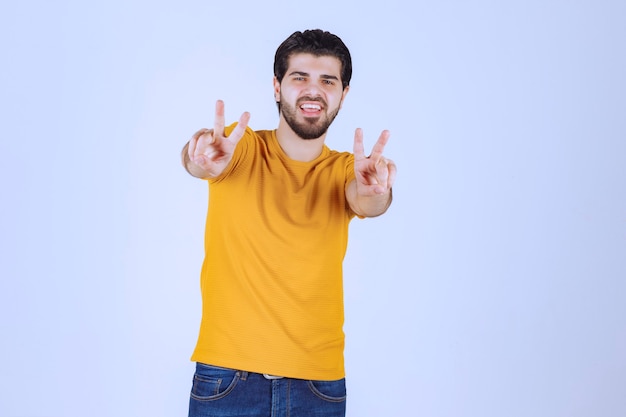 Man showing peace and friendship sign in the hand