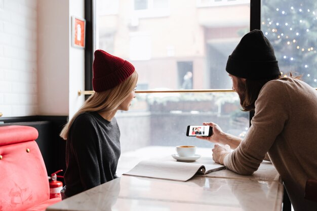 Man showing photo on smartphone