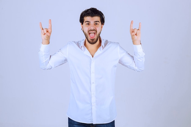 Free photo man showing rabbit or wolf hand sign.