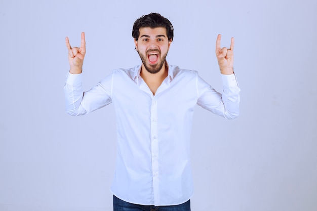 Man showing rabbit or wolf hand sign. 