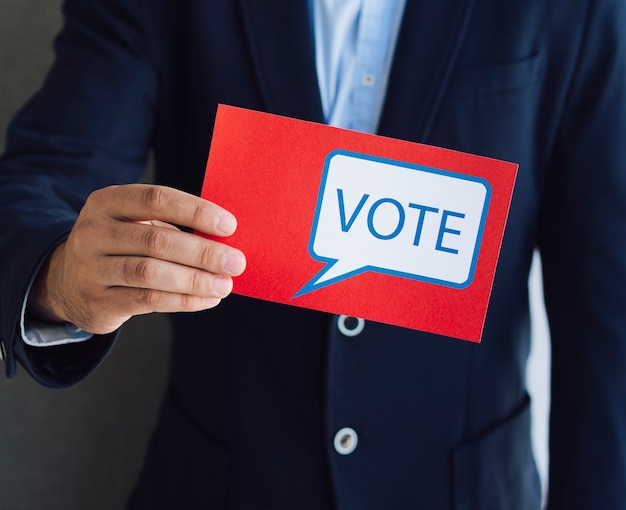 Man showing a red ballot to the camera