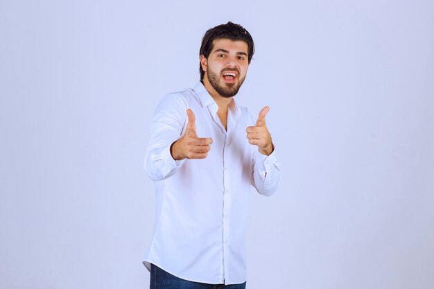 Man showing thumb up hand sign.