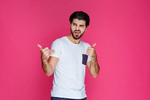 Man showing thumb up sign to someone. 