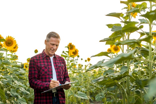 Man signing on a clipboard in a field