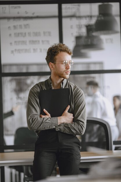 Man signs the documents. Businessman sitting on the table. Manager working in the office.