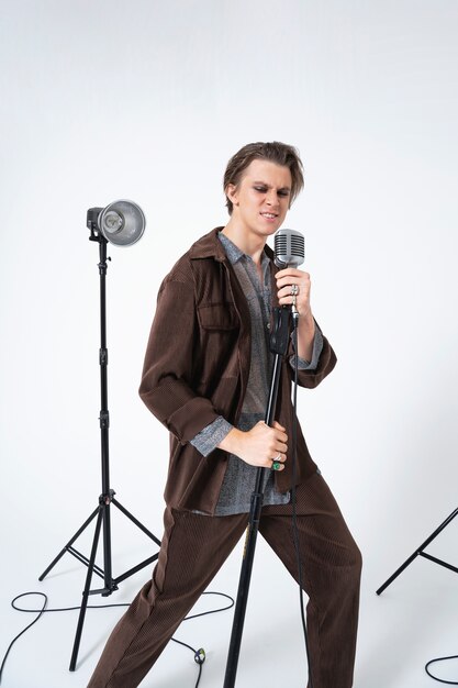 Man singing with microphone full shot