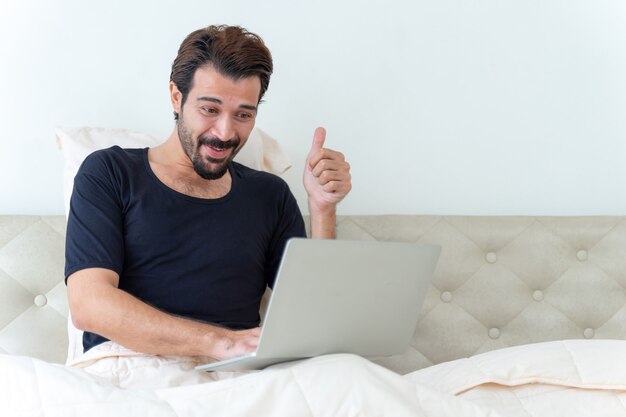 man sitting on bed 