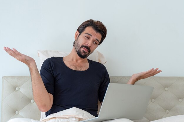 man sitting on bed 