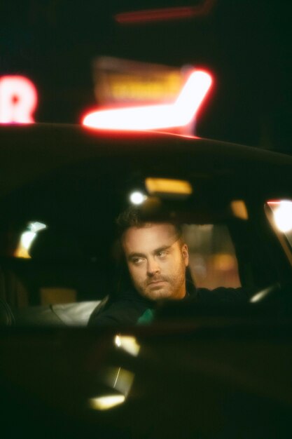 Man sitting in the car at night