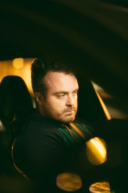 Man sitting in the car at night