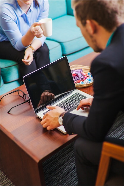 Man sitting on chair using laptop