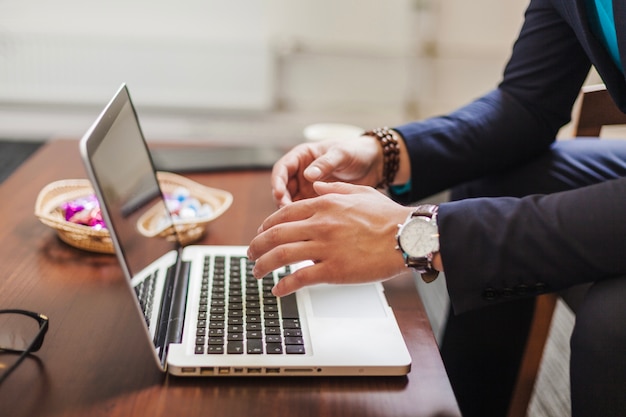 Man sitting in chair using laptop