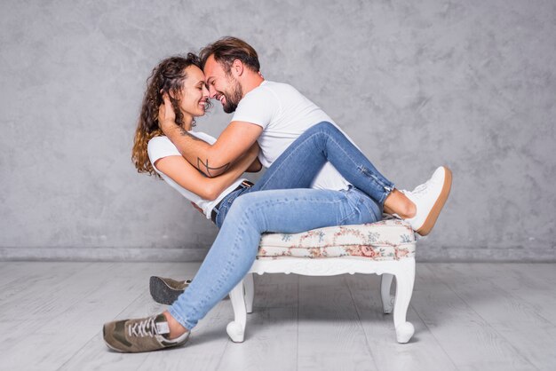 Man sitting on chair with woman