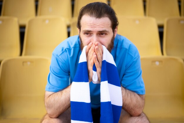 Man sitting on grandstands front view