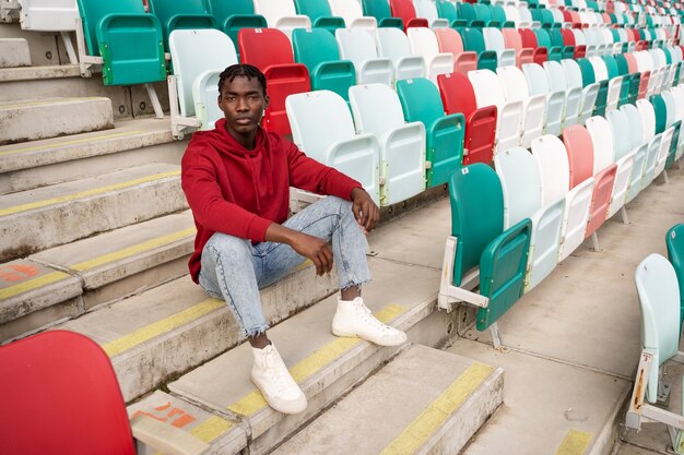 Man sitting on grandstands high angle