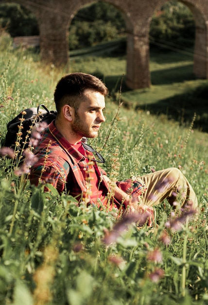 Man sitting in green field