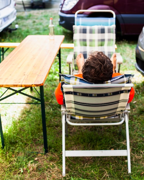 Man sitting in a lounge chair from behind