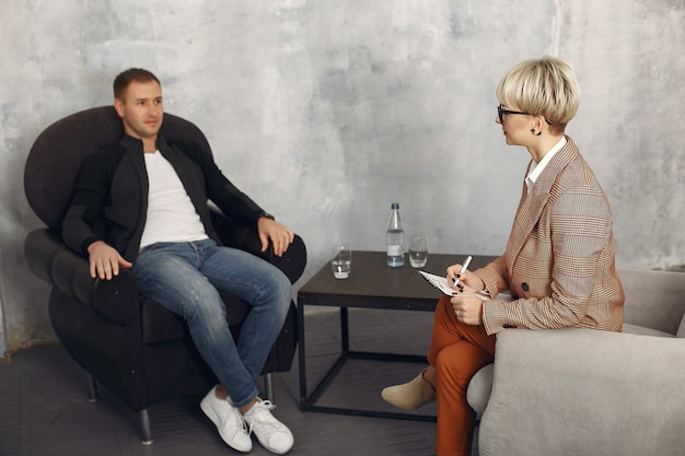 Man sitting in the psychologist's office and talking about problems