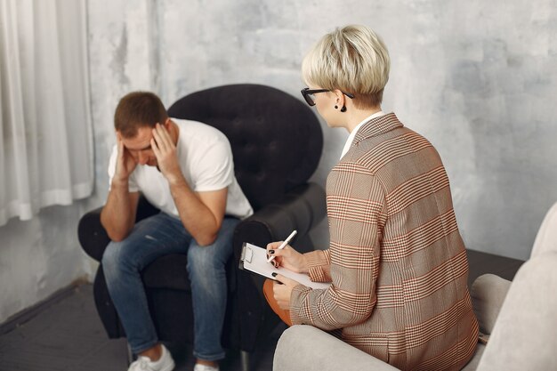 Man sitting in the psychologist's office and talking about problems