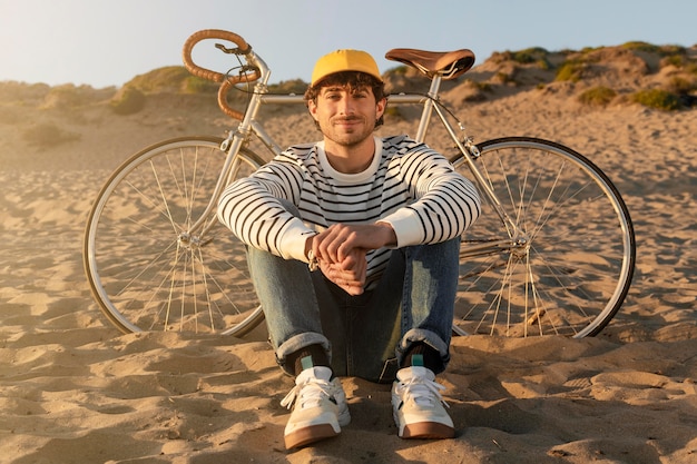 Man sitting at seaside full shot