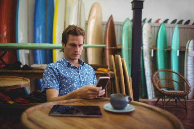 Man sitting in surfboard shop