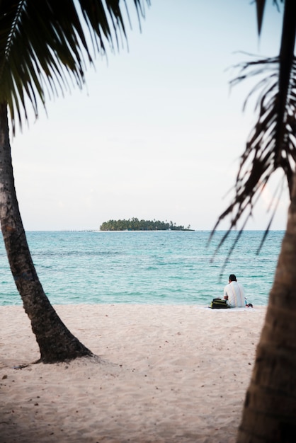  man sitting on tropical island