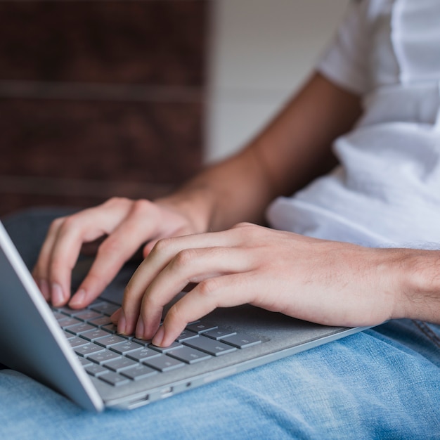 Man sitting and typing on laptop