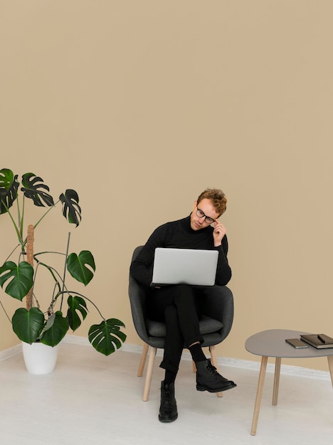 Man sitting while working on laptop