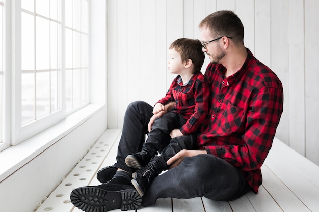 Foto gratuita equipaggi la seduta con il figlio il giorno di padri