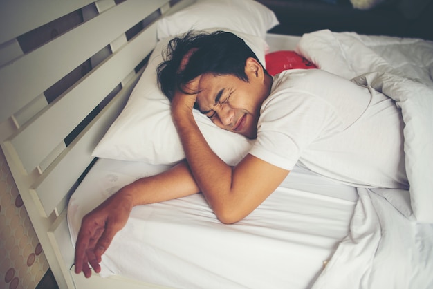 Man sleeping on bed in the morning