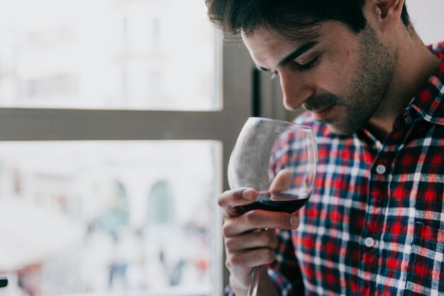 Man smelling on wine