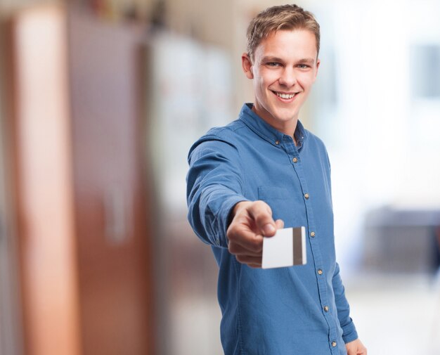 Man smiling giving a credit card