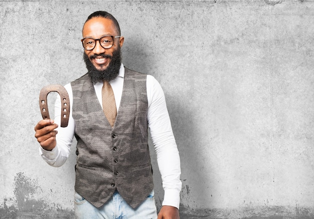 Man smiling holding a horseshoe