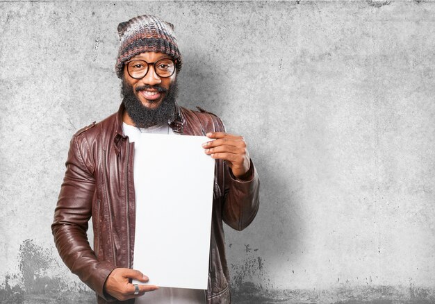 Man smiling holding a white sign