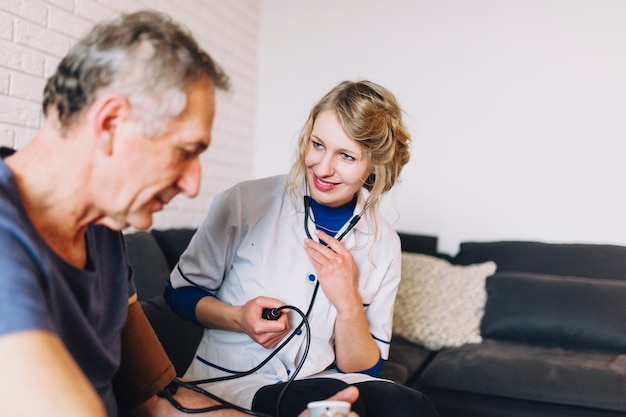 Man and smiling nurse in old age home