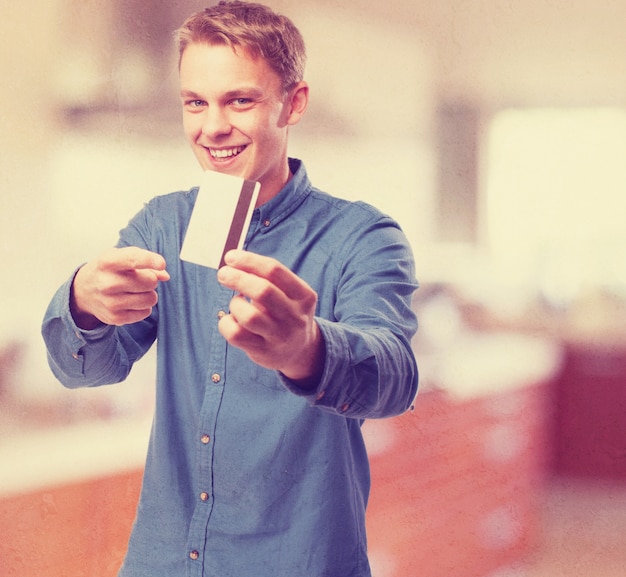 Man smiling and pointing a credit card