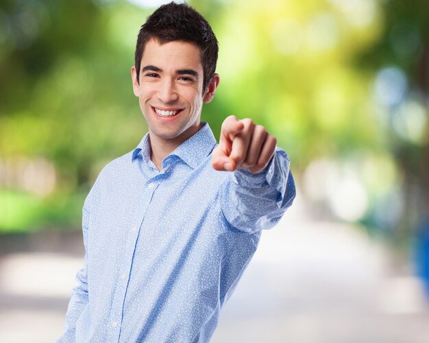 Man smiling pointing to front