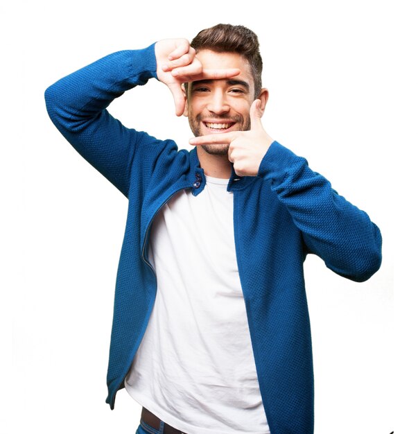 Man smiling while making a frame with his fingers