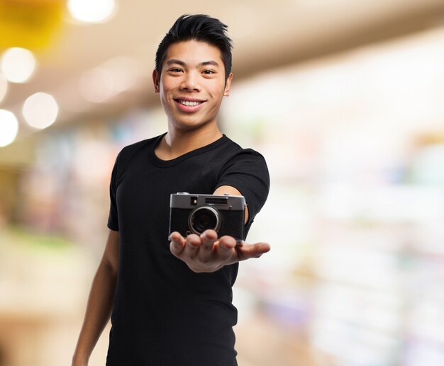 Man smiling with a camera in his hand