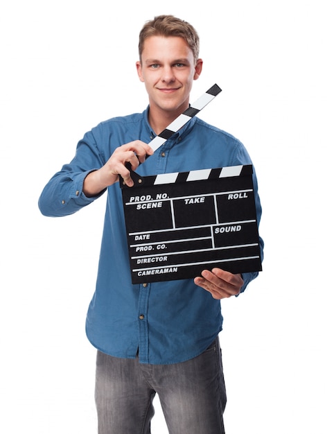Free photo man smiling with a clapperboard