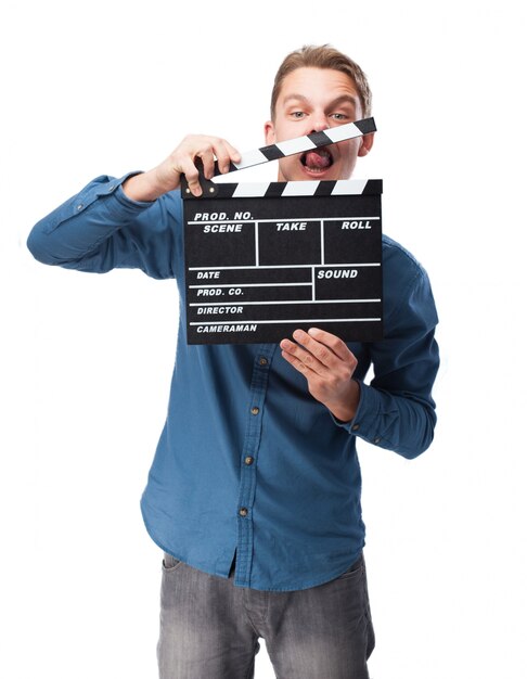 Man smiling with a clapperboard