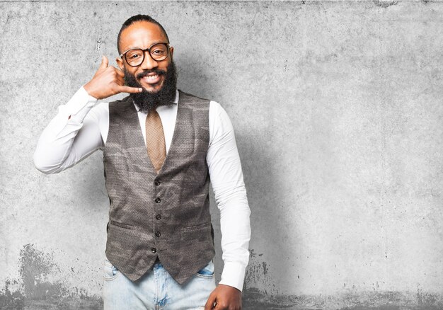 Man smiling with a hand on face as a phone