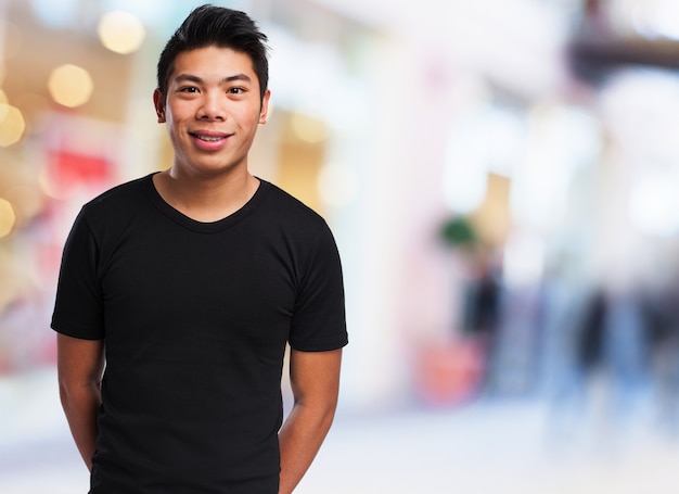 Free photo man smiling with hands behind his back