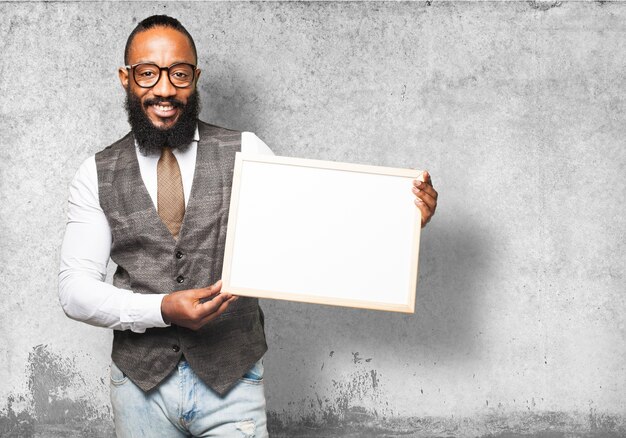 Free photo man smiling with tie holding a white board
