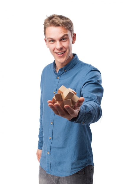 Free photo man smiling with a wooden game