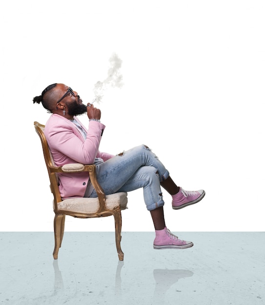 Man smoking sitting on a chair