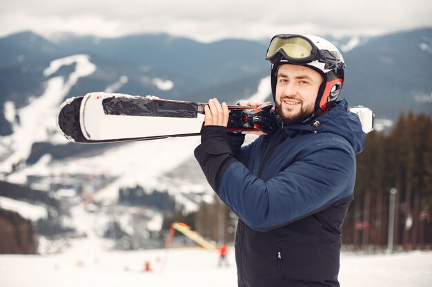 Man in snowboard suit. Sportsman on a mountain with a snowboard in the hands on the horizon. Concept on Sports