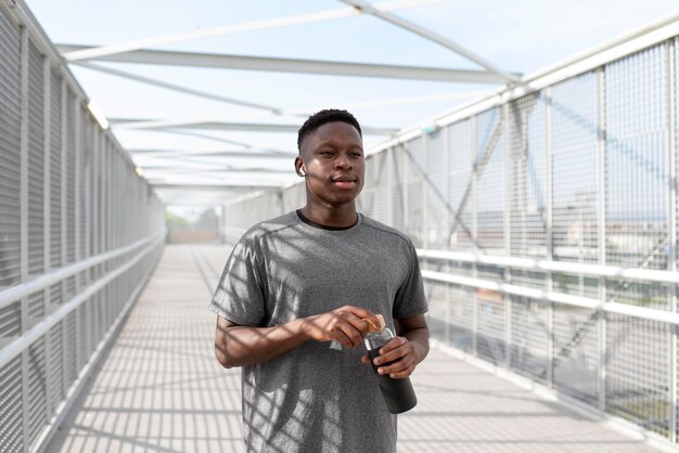 Man in sportswear holding a bottle of water