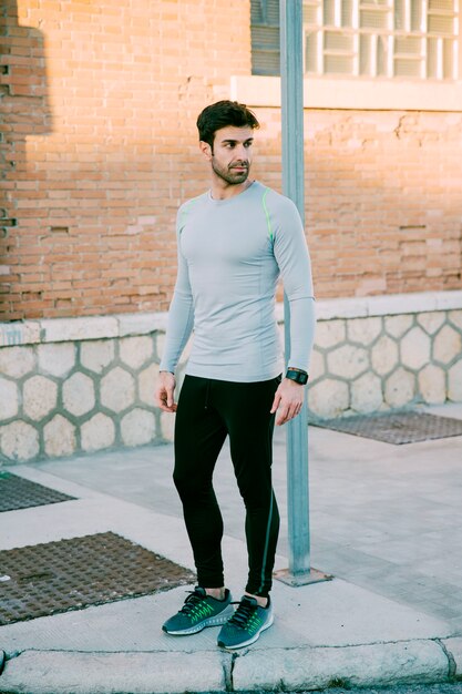 Man in sportswear on pavement