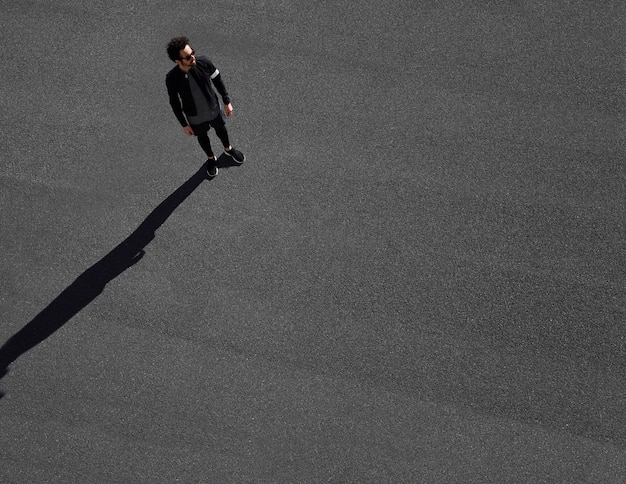 Man in sportswear on road top view